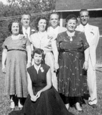 Standing -- Concetta, John, Mary, Frank, Anna, and Joseph, kneeling is Rose, at the farm, 1954.